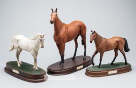 A trio of Royal Doulton models of champion steeplechase racehorses, two of thee triple Grand