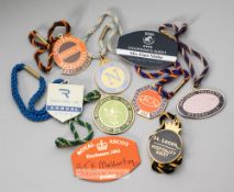 A collection of metal racing badges from the Stan and Elain Mellor collection, mostly dating from