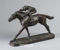 A bronze resin sculpture of a racehorse and jockey, depicting a realistic model of jockey on