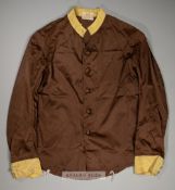 A set of Colonel William H Whitbread chocolate racing silks,  with yellow collar and cuffs,