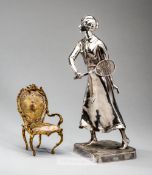 Kayzerzinn silvered lady Lawn Tennis player, early 20th century, modelled standing with a racquet