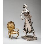 Kayzerzinn silvered lady Lawn Tennis player, early 20th century, modelled standing with a racquet