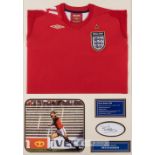 Bryan Robson signed England display, comprising red England retro jersey embroidered with national