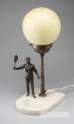 An early tennis lamp, circa 1920, with spelter tennis figure, stand and marble base, 40 by 22 by