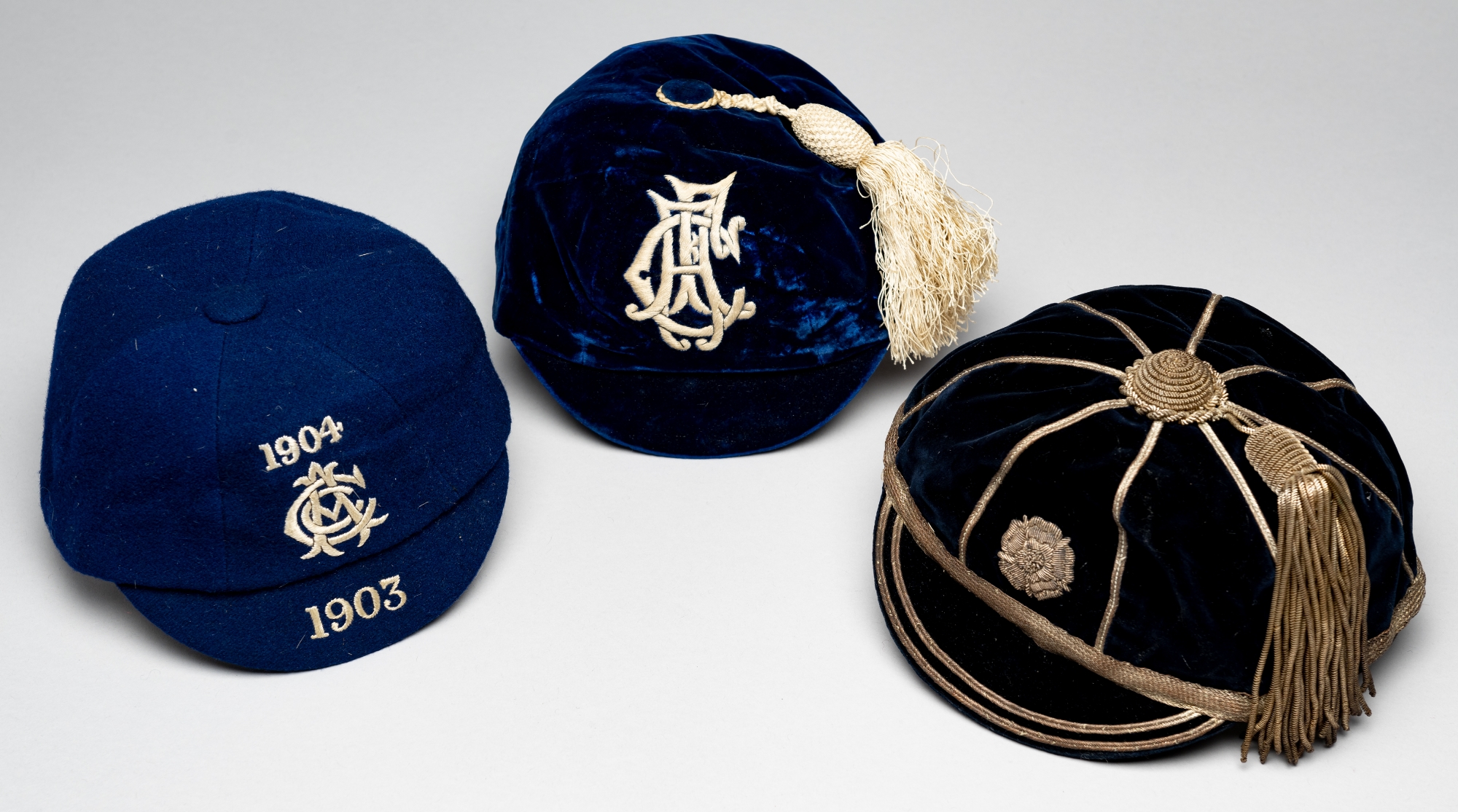Three representative caps awarded to A Burn Murdoch, circa 1900s, comprising navy velvet cap with