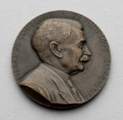 A bronze medal commemorating Pierre de Coubertin and the 50th anniversary of the International