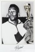 1962 World Cup b&w print featuring Pele holding the Jules Rimet Trophy, signed by Pele in black