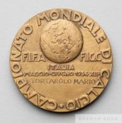 A rare FIFA 1934 World Cup official participation medal awarded to Dr Mario Tortarolo