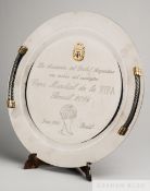 A white metal circular plate presented to Brazil in commemoration of the 2014 World Cup from the