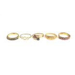 Five yellow gold rings.