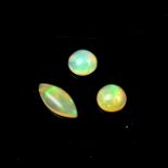 Three loose marquise and circular cut opals.