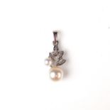 14 ct white gold pearl and diamond pendant.