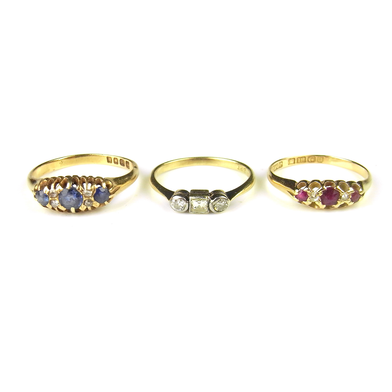 Three gem set rings.