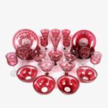 A large collection of late Victorian cranberry overlay glass