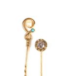 Two yellow gold gem set tie pins.