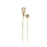 Two yellow gold gem set tie pins.