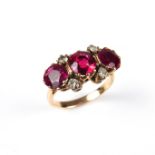 18 ct yellow gold three stone synthetic ruby and diamond ring.