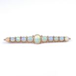 Large and impressive yellow gold graduated opal and diamond bar brooch.