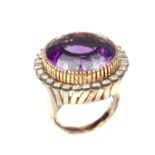 Yellow metal amethyst and diamond cocktail ring.