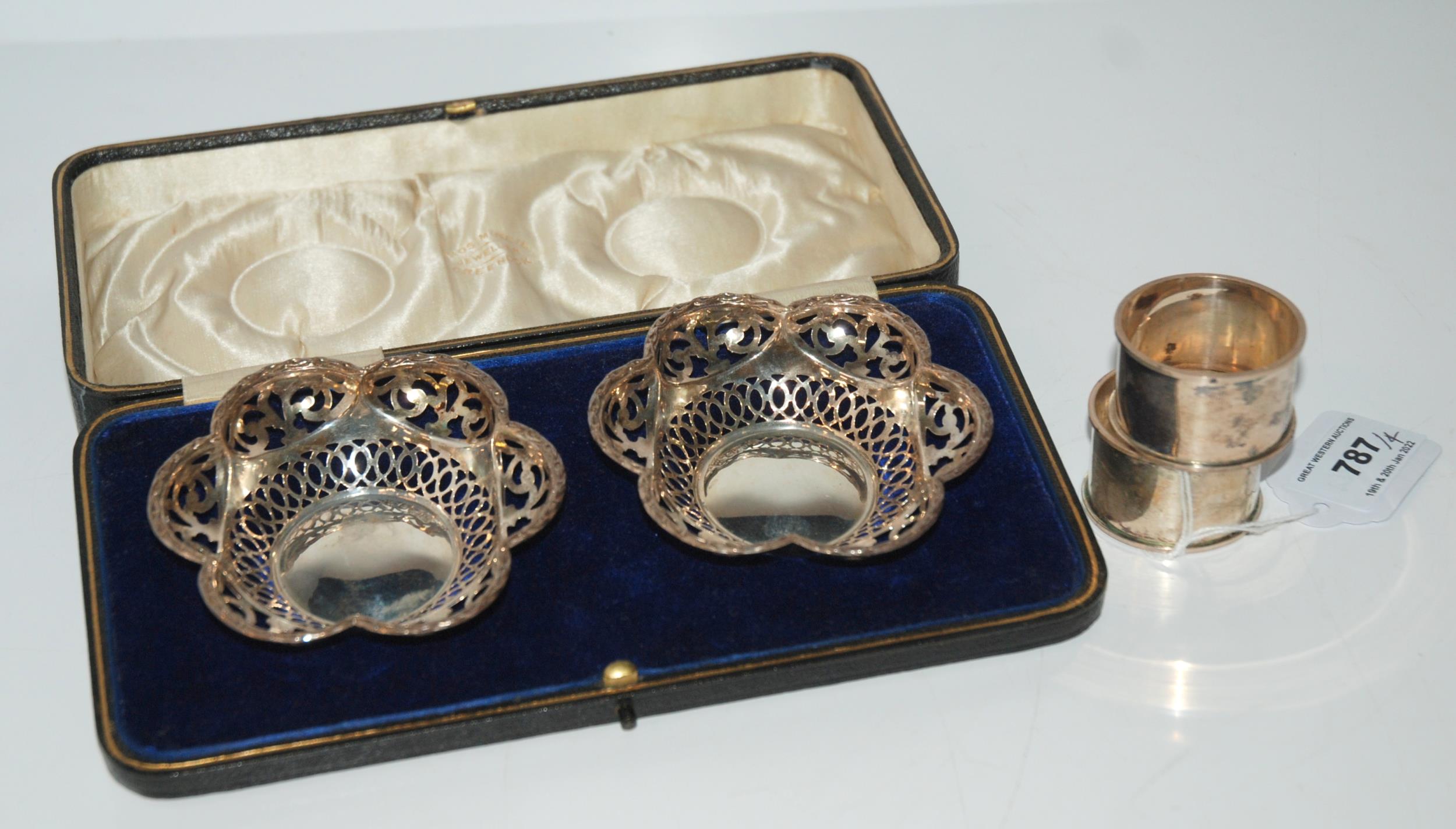 A lot comprising a cased pair of silver bonbon dishes, Birmingham 1915, 9.3cm diameter and a pair of