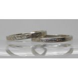 A platinum wedding band size L, with delicate engraving, together with another unhallmarked