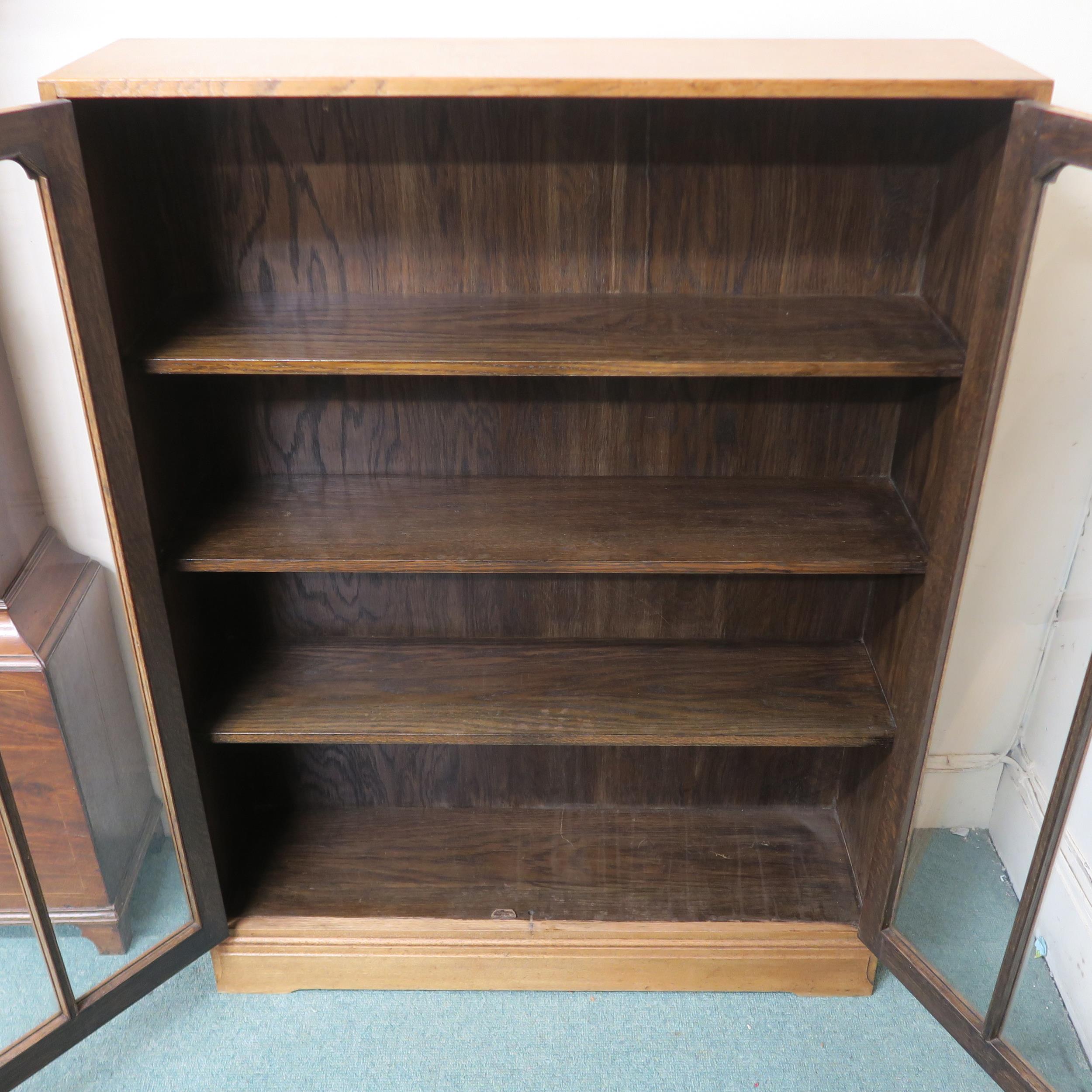 An early 20th century oak art deco two door glazed bookcase three internal shelves 112cm high x 92cm - Image 4 of 4