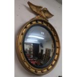 A 20th century gilt framed circular convex mirror with a gilt eagle to top 66cm high x 53cm wide