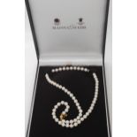 A string of white pearls with an 18ct gold clasp, retailed by Mappin & Webb, with original box.