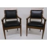 A pair of early 20th century oak framed armchairs with leather upholstery 99cm high Condition