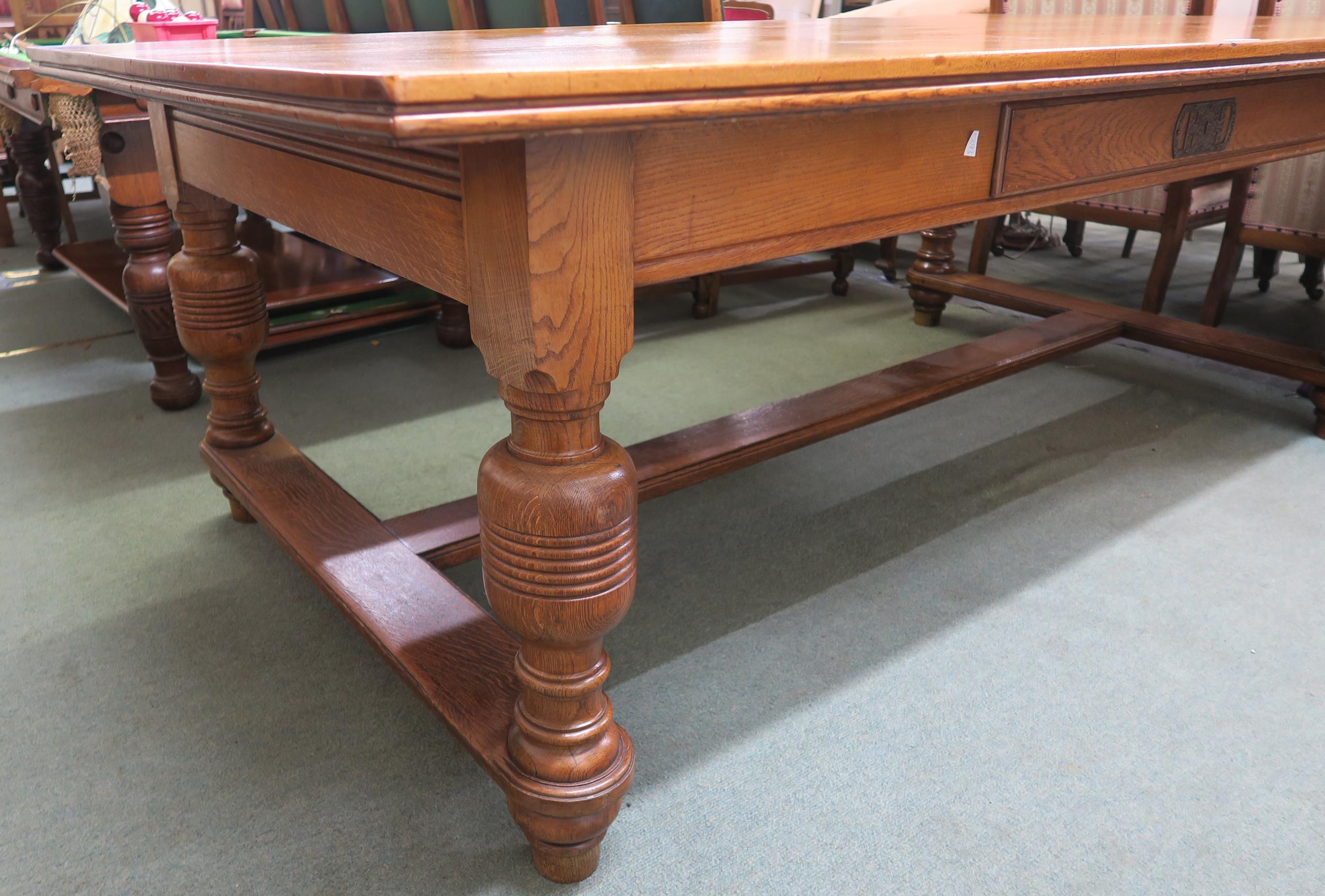 An early 20th century oak library table with a single drawer to both sides on stretchered baluster - Image 2 of 5