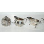 A lot comprising a silver cream jug, Sheffield 1885 97 grams, a silver sauceboat, Birmingham 1936 80