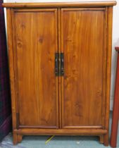 An early 20th century Chinese hardwood two door cabinet with two internal drawers 112cm high x