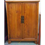 An early 20th century Chinese hardwood two door cabinet with two internal drawers 112cm high x