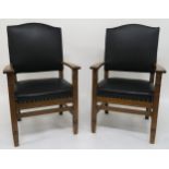 A pair of early 20th century oak framed armchair with black leather upholstery 112cm high