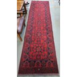 A red ground eastern style runner 294cm long x 83cm wide Condition report: Available upon request