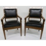 A pair of early 20th century oak framed armchairs with leather upholstery 99cm high Condition