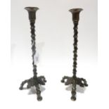 A pair of patinated brass candlesticks, with knobbly stems and leaf detail Condition report: