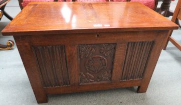 An early 20th century oak linen fold coffer with carved rose motif 52cm high x 80cm wide x 50cm deep