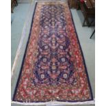 A blue ground Hamedan runner with allover floral design 293cm long x 111cm wide Condition report: