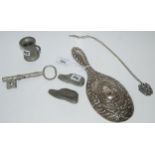 A lot comprising a silver-backed hair brush, Birmingham 1902, a large key measure, white-metal