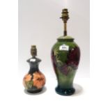Two Moorcroft table lamps including anemone and hibiscus. Anemone has been broken and mended.