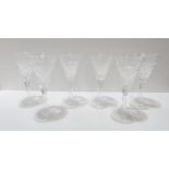 A set of six cut glass champagne glasses, unmarked One damaged.