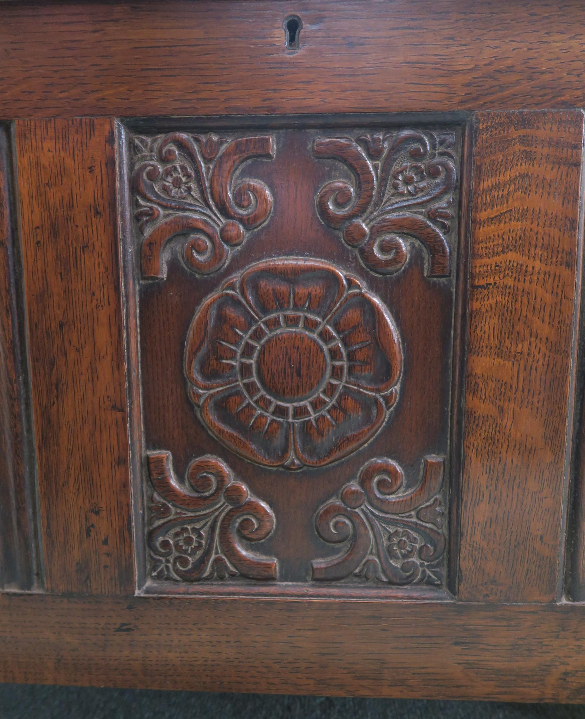 An early 20th century oak linen fold coffer with carved rose motif 52cm high x 80cm wide x 50cm deep - Image 2 of 3