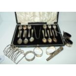 A lot comprising a cased set of EP coffee spoons & tongs with a silver toast rack, Sheffield 1925,
