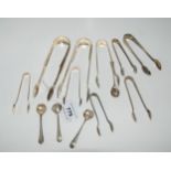 A lot comprising nine pairs of assorted silver sugar tongs & four assorted silver mustard spoons (