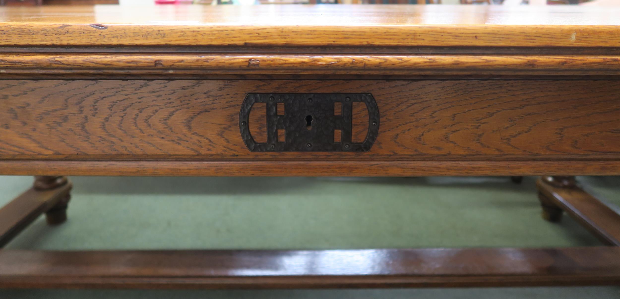 An early 20th century oak library table with a single drawer to both sides on stretchered baluster - Image 3 of 5