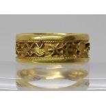 A bright yellow metal wide band ring with applied design of zodiac symbols, size O1/2, weight 6.8gms