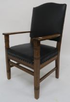 An early 20th century oak framed armchair with black leather upholstery 112cm high Condition report: