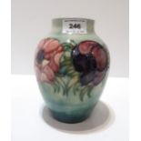 A Moorcroft Anemone pattern vase on pale blue ground lightly crazed.