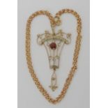 An Edwardian 9ct gold pendant set with garnet and clear gems, with a 9ct belcher chain, length 45cm,